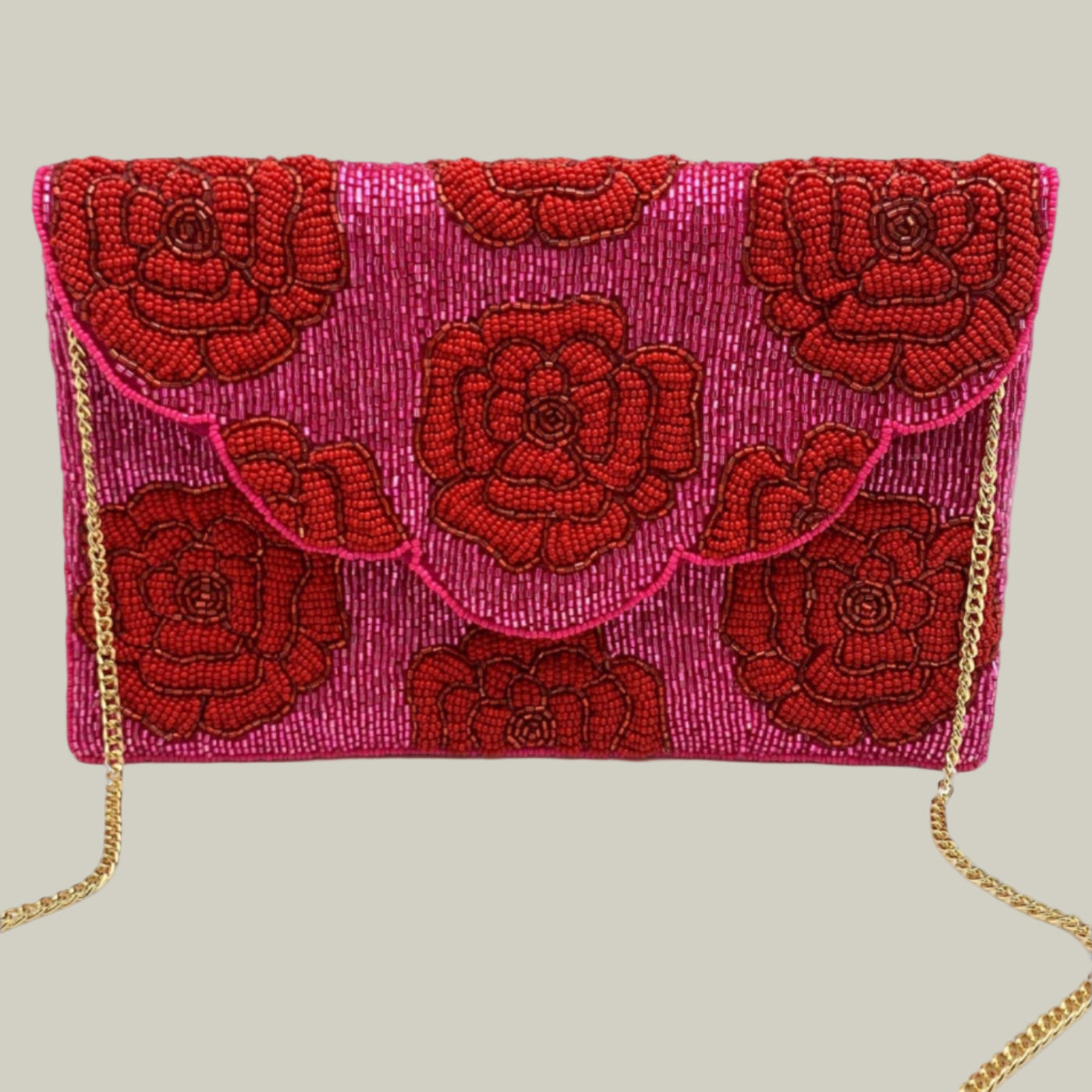 Pink clutch bag with red floral embroidery and gold chain strap