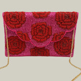 Pink clutch bag with red floral embroidery and gold chain strap