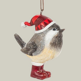 Decorative winter chickadee ornament wearing a Santa's hat and red boots on a pale green background