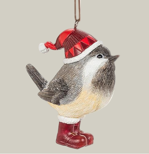 Decorative winter chickadee ornament wearing a Santa's hat and red boots on a pale green background