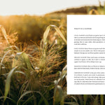 Field of grass with a white paper overlay containing text.
