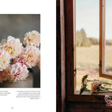 Floral arrangement on a table next to a window with a scenic view.