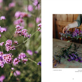 Floral arrangement with a blurred background of pink flowers and a person arranging flowers.