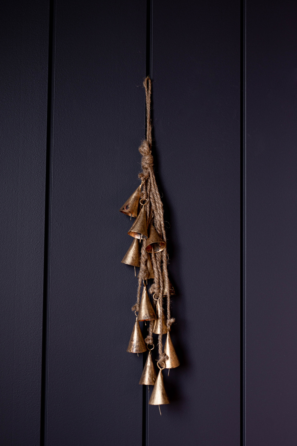 Vintage inspired bronze hanging bells on a dark background