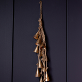 Vintage inspired bronze hanging bells on a dark background
