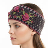 Beautiful hand-knit headband with floral embroidery on a young woman