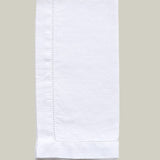 White folded napkin on a light gray background