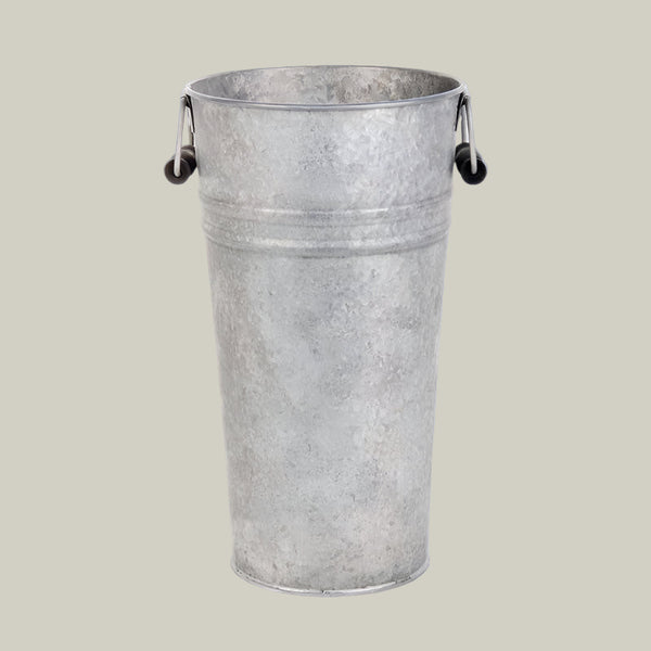 Metal bucket with handles on a light blue background