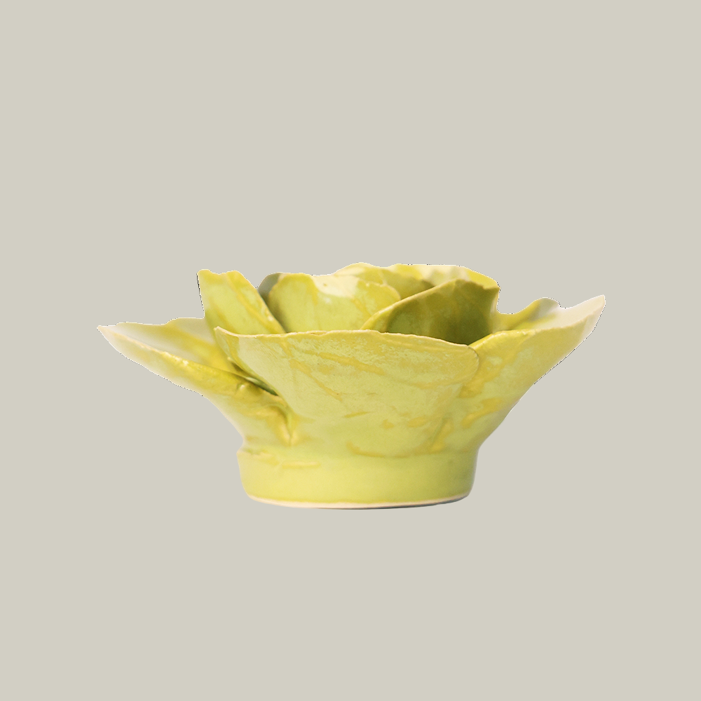 The side view of a green ceramic stargazer lily sculpture