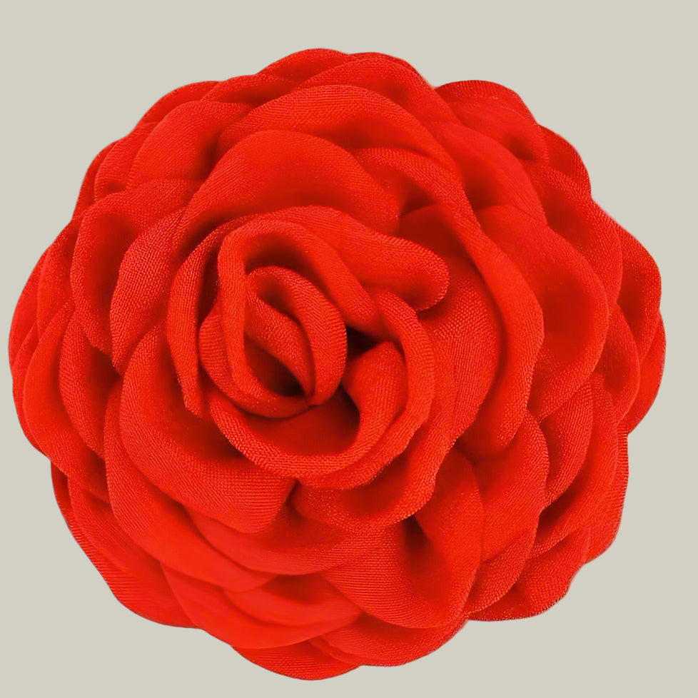 Red fabric flower fabric hairclip on a white background