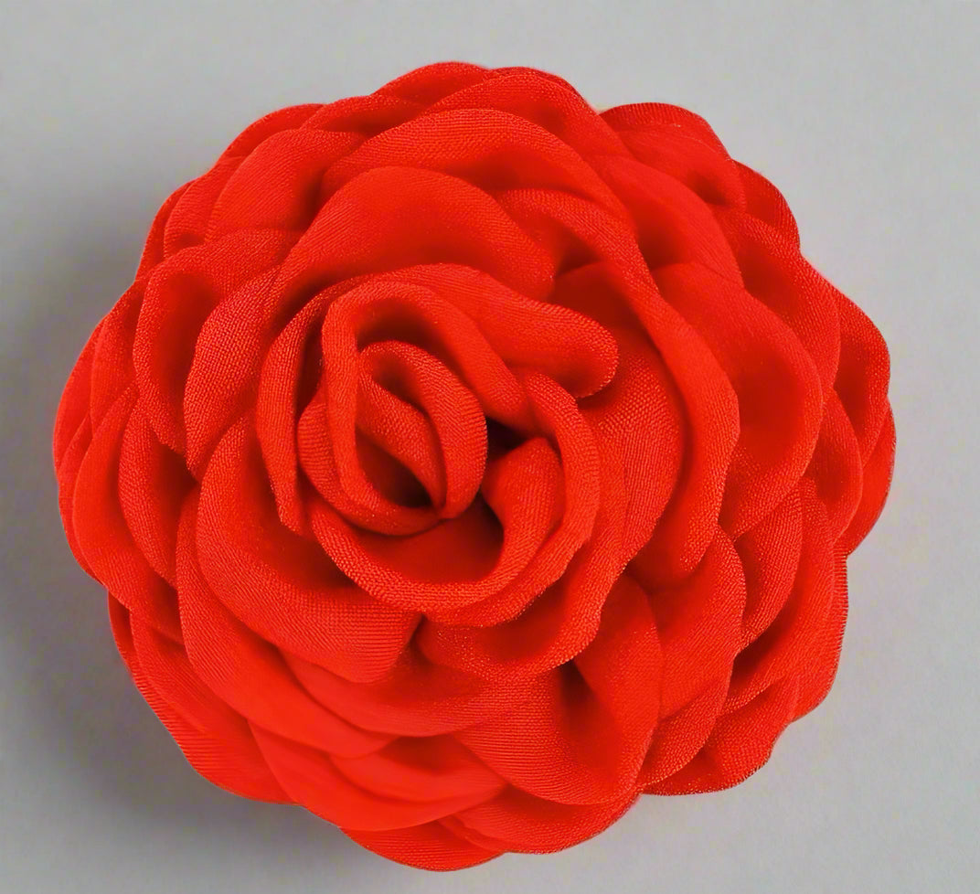 Red fabric flower fabric hairclip on a white background