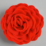 Red fabric flower fabric hairclip on a white background